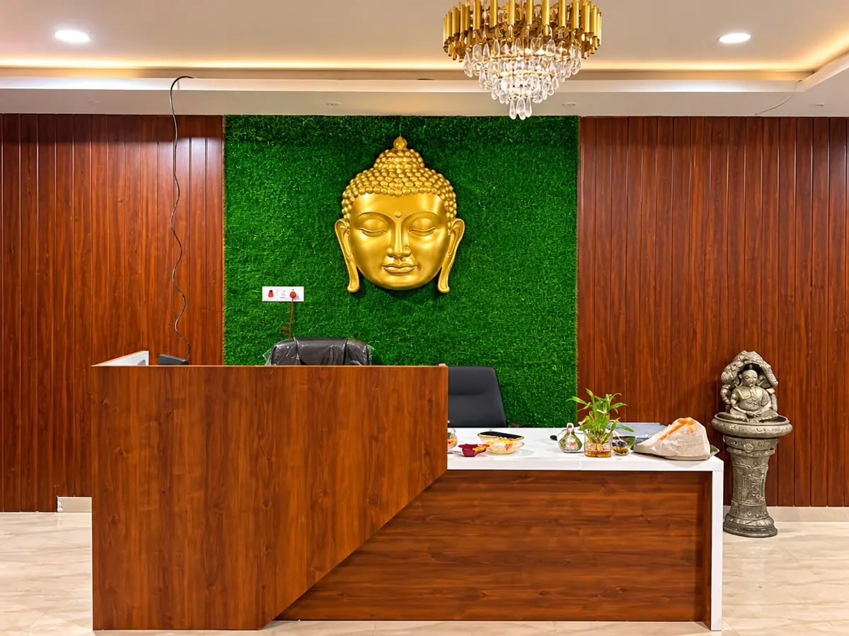 Reception at Diamond Wellness Spa, Shivaji Nagar, with a golden Buddha on a green wall
