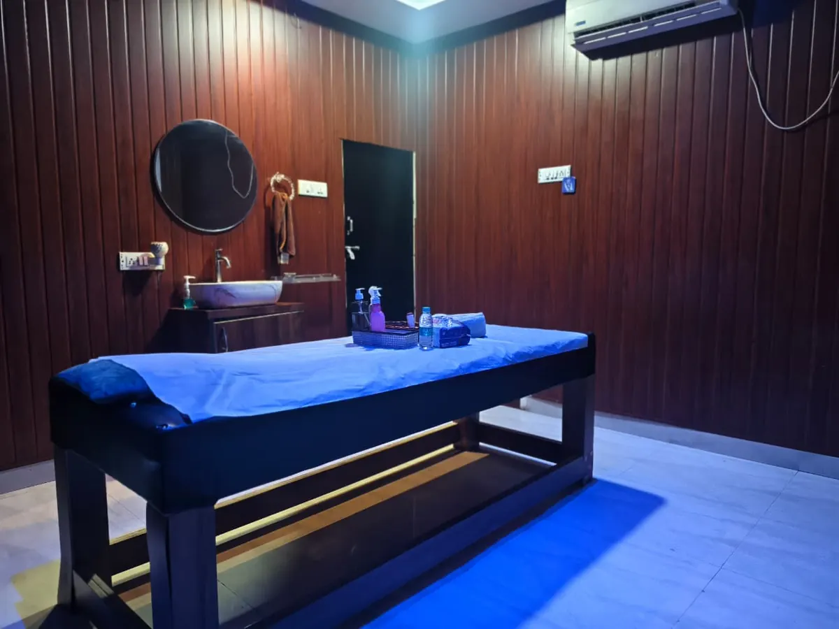 One of the treatment rooms at Diamond Wellness Spa, with a massage table and wash basin