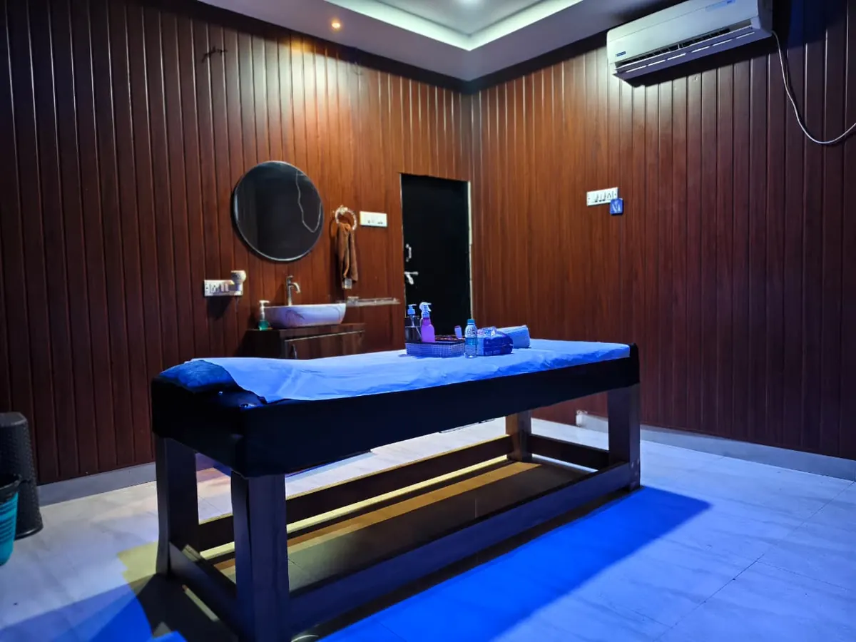 Treatment room at Diamond Wellness Spa with wood-panelled walls and a massage table
