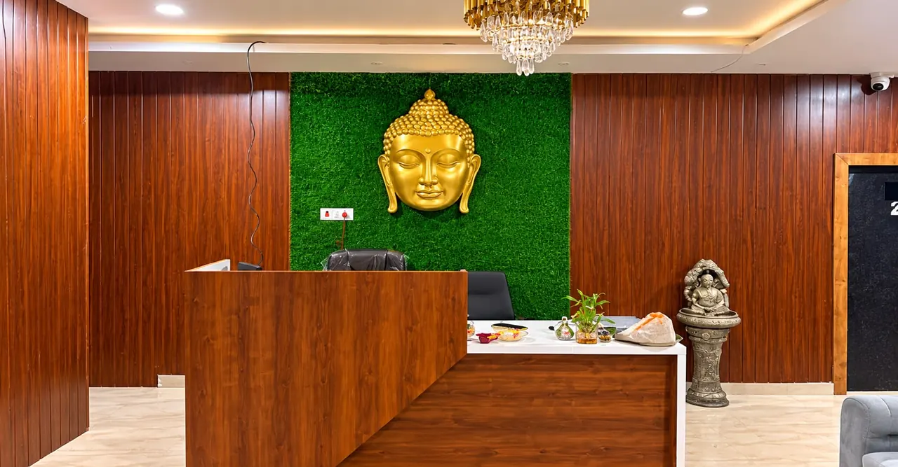 Reception at Diamond Wellness Spa, Shivaji Nagar, with a golden Buddha on a green wall